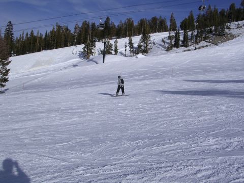 1983 Ferrari Enzo - A snowboarder navigates a groomed ski slope with ski lift infrastructure visible in the background.