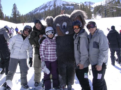 1983 Ferrari Enzo - A group of skiers and snowboarders pose for a photo with a mascot at a ski resort.