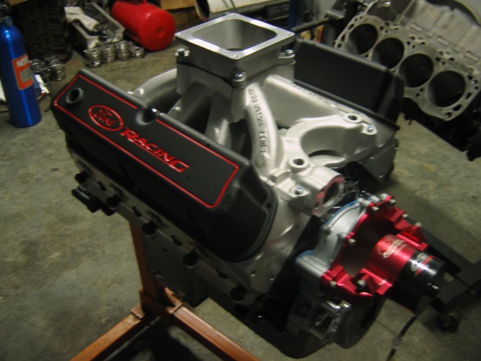 Ford Racing valve cover on an engine assembly on a stand