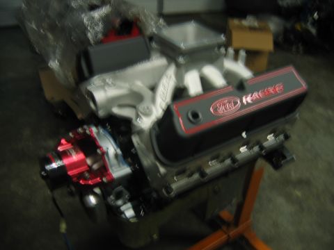 1992 Ford Mustang - Engine assembly with "Ford Racing" branding on the valve covers sits on an orange stand.