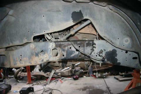 1991 Ford Bronco - Undercarriage view of a vehicle's frame and suspension system, showing signs of rust and wear.