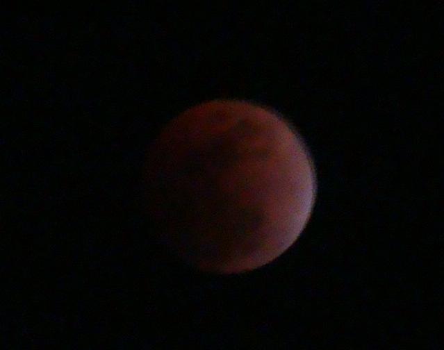 Red moon in dark sky