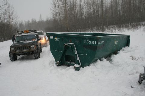2003 Jeep TJ - Two Jeep Cherokee XJs and a dumpster are seen in a snowy Kincaid Park during a cleanup operation.