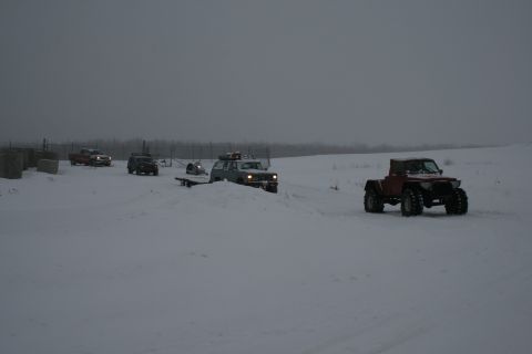 2003 Jeep TJ - Multiple off-road vehicles navigate a snow-covered landscape.