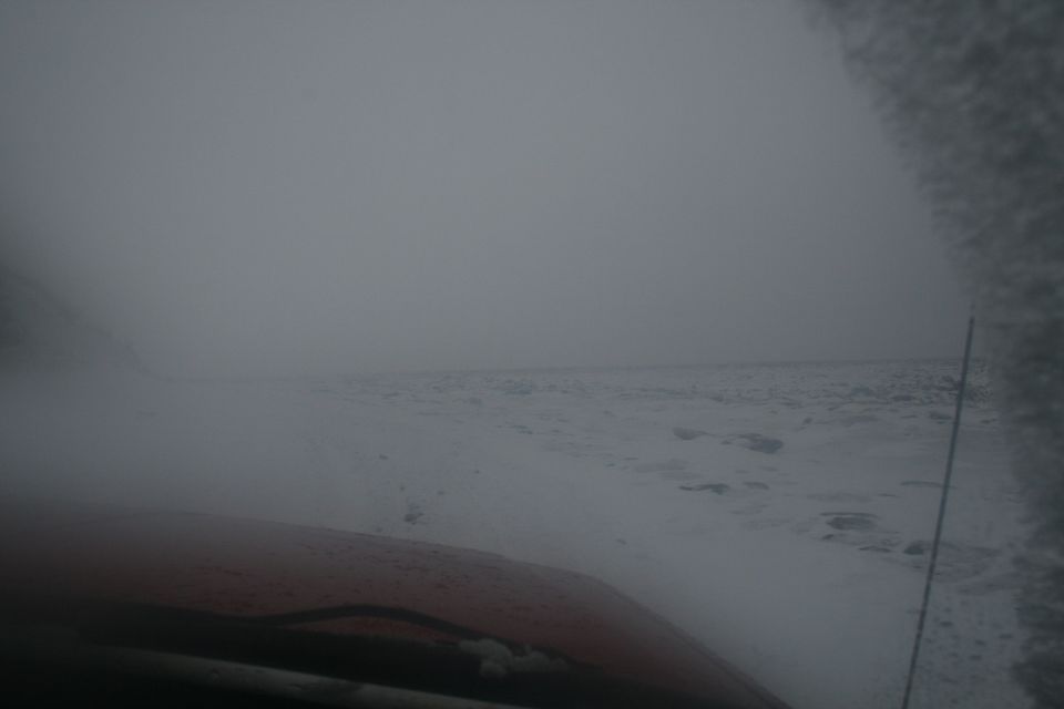 view from inside vehicle driving through snowstorm