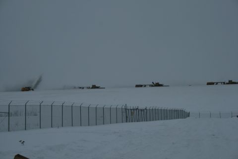 2003 Jeep TJ - Heavy machinery is deployed across a snowy landscape, clearing snow under overcast conditions.
