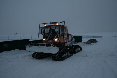 2003 Jeep TJ - A snow groomer labeled "MOOSE FORCE ONE" operates in a snow-covered area, possibly during a cleanup operation.