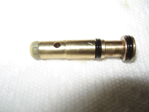 1968 Shelby GT500 - A brass proportioning valve with O-rings and a small hole is shown against a white textured background.
