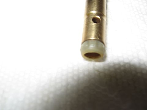 1968 Shelby GT500 - Brass proportioning valve with a beige plastic seal, likely a replacement part.
