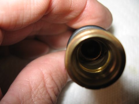 1968 Shelby GT500 - Close-up of a brass proportioning valve, held for inspection.