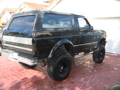 1994 Ford Bronco - This 1994 Ford Bronco features a lifted suspension and a distinctive black and silver paint scheme.