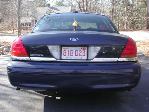 1999 Ford Crown Victoria - Rear view of a dark blue Ford Crown Victoria with chrome accents and a Massachusetts license plate.