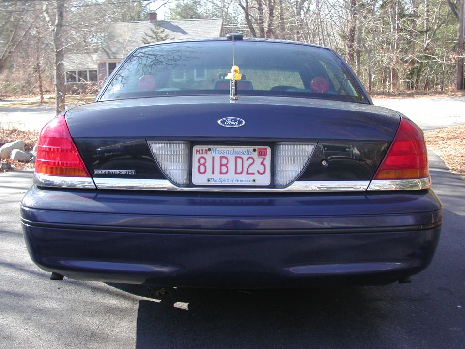 Dark blue Ford Crown Victoria rear view, chrome trim, Massachusetts license plate 81B D23