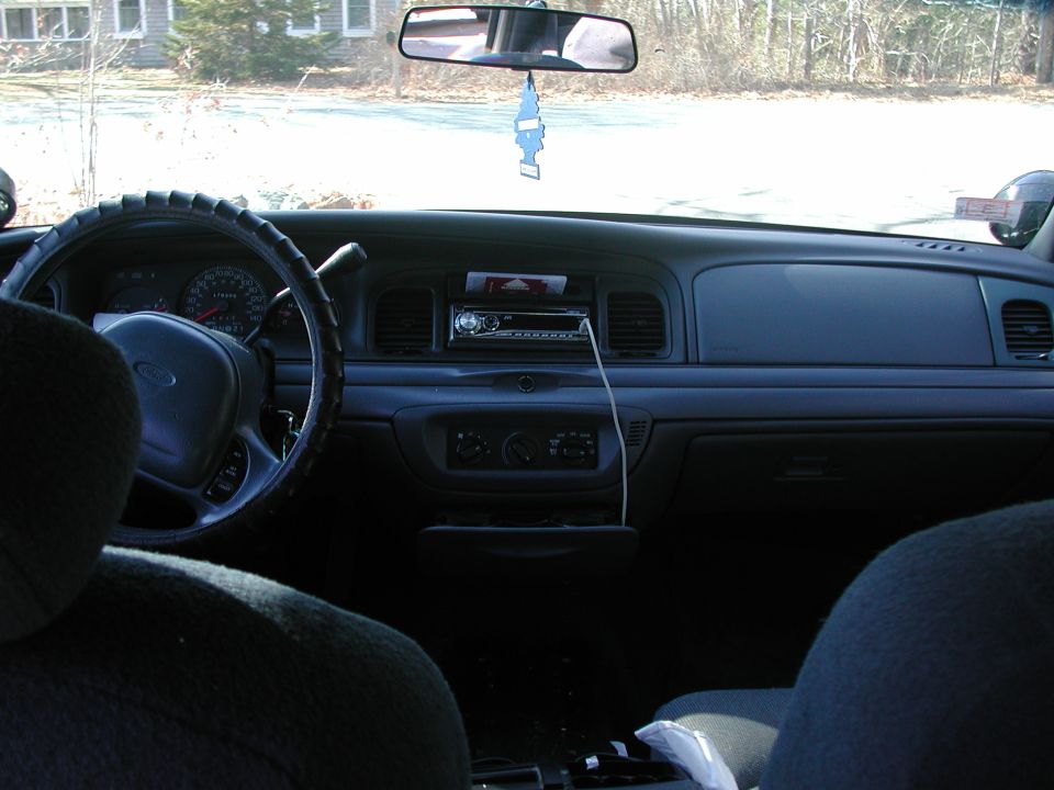 Interior view of a 1998 Ford Crown Victoria showing the dashboard, steering wheel, and radio