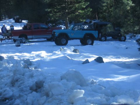1989 Ford Bronco - Several vehicles are parked in a snowy area, possibly during an outdoor event or trip.