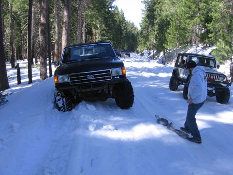 1989 Ford Bronco - Ford F-Series truck navigating a snowy road with a Jeep in the background.
