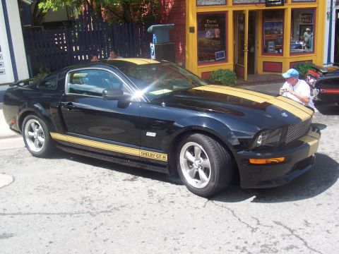 1973 Ford Mustang - This black Shelby GT-H Mustang features distinctive gold racing stripes and side decals.