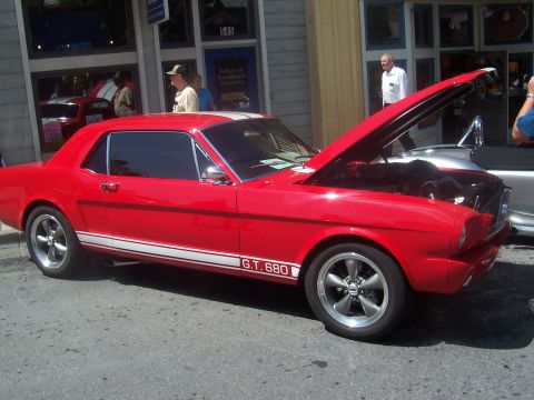 1973 Ford Mustang - This red coupe, identified by its body style and "G.T. 680" decal, appears to be a 1965 Mustang, not a 1973 as the registry suggests.