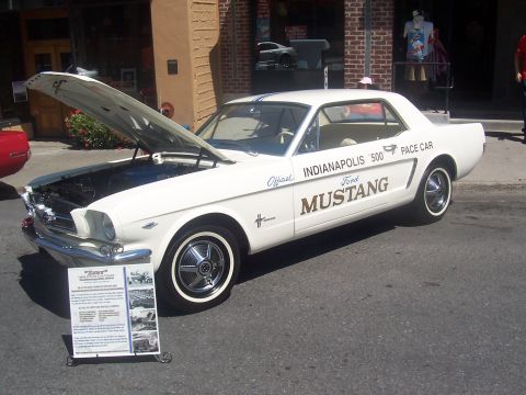 1973 Ford Mustang - This white 1965 Ford Mustang served as the Indianapolis 500 Pace Car, distinguished by its special livery and open hood.