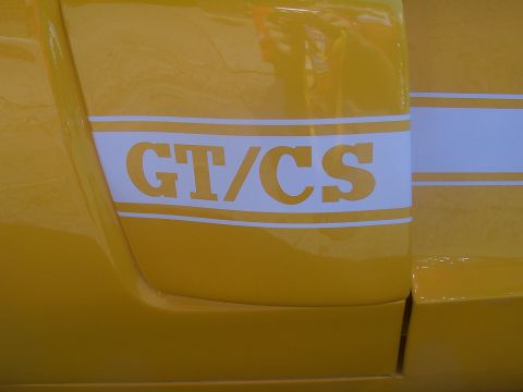 1973 Ford Mustang - Close-up of a yellow car's side panel a white GT/CS stripe.