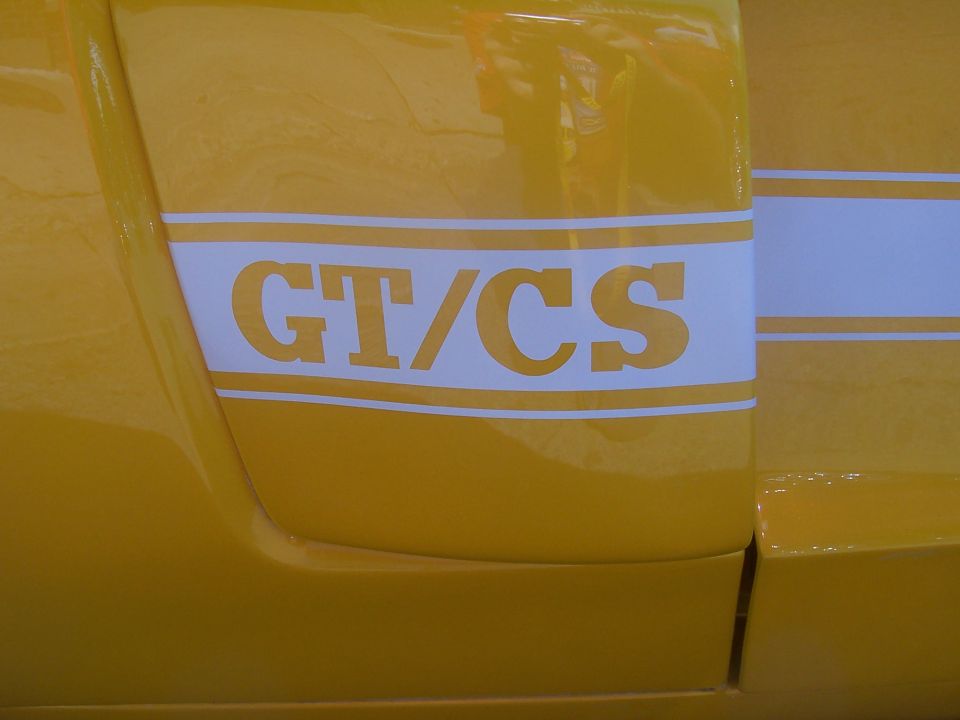 Yellow car side panel with white GT/CS stripe