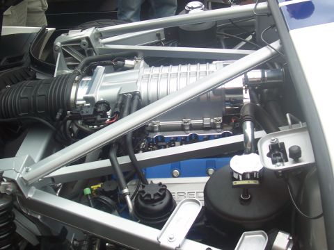 1973 Ford Mustang - Engine bay detail showing a supercharged V8 motor with prominent intake and exhaust components.