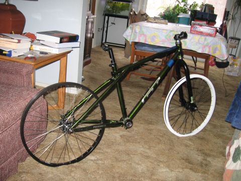1997 Ford Probe - A green bicycle frame with its front and rear wheels is shown indoors, leaning against furniture.