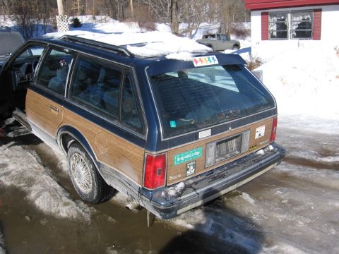 1999 Ford Taurus - This station wagon, with its distinctive wood paneling, is parked in a snowy, icy environment.