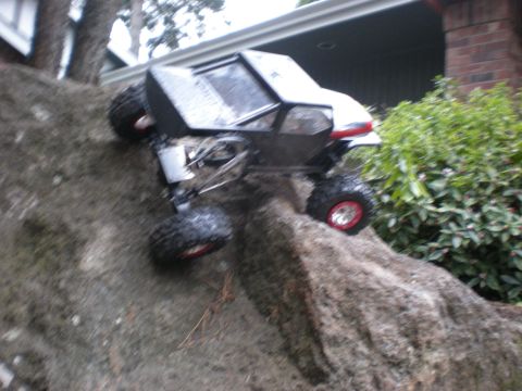 1993 Ford Bronco - RC rock crawler navigating a rocky terrain outdoors.