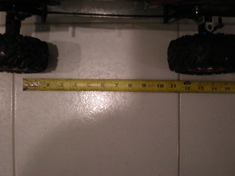 1993 Ford Bronco - A yellow measuring tape is placed next to two tires of what appears to be a remote control car.