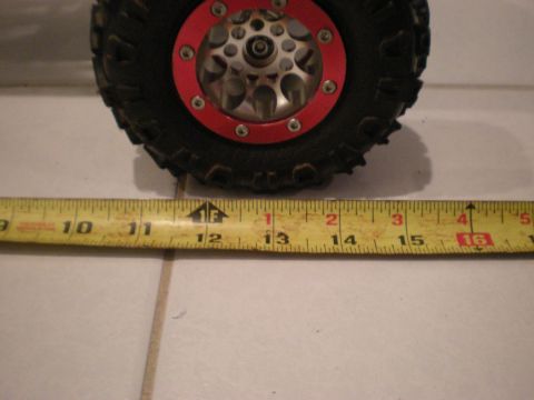 1993 Ford Bronco - A close-up of a tire and wheel assembly is shown with a measuring tape for scale.
