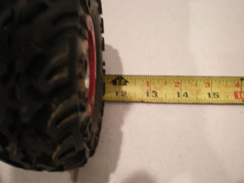 1993 Ford Bronco - A tire is measured with a tape measure, indicating a width of approximately 12.5 inches.