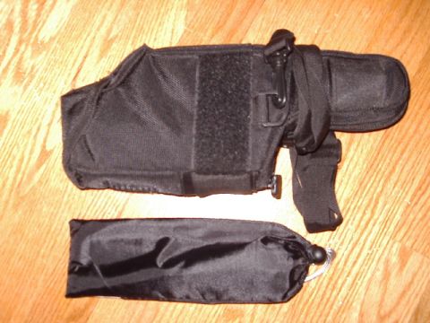 1985 Ford Bronco - A black tactical holster and a separate black pouch are displayed on a wooden surface. The image includes a Supermotors.net watermark.