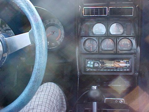 1977 Chevrolet Corvette - View of the car's interior, showing the dashboard with multiple gauges and a stereo system.