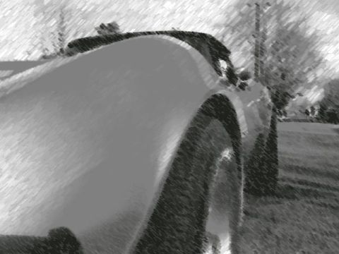 1977 Chevrolet Corvette - The image shows a close-up of a car's rear quarter panel and wheel, with a watermark at the bottom.