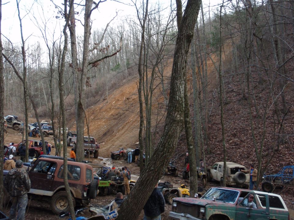 Winter off-road trail gathering with Jeep CJ, mud-covered trucks, buggy and ATVs