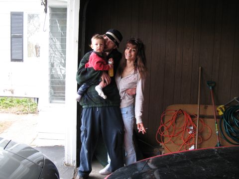 1996 Ford Probe - A family poses for a photo inside a garage, with various items stored in the background.
