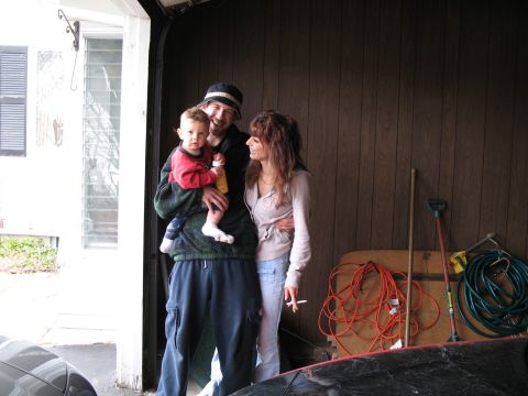 1996 Ford Probe - Family poses for a photo inside a garage, with various items stored in the background.