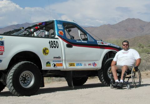 2000 Ford F-150 - Off-road race truck with driver in wheelchair, desert background.