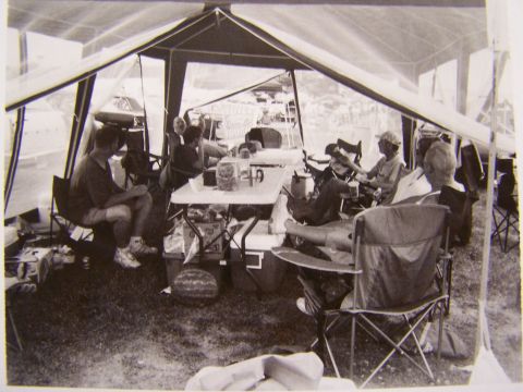1973 Ford Ranchero - A group of people are relaxing and socializing under a large tent at an outdoor event.