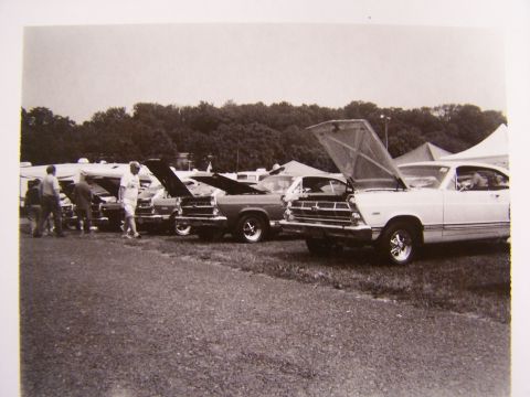 1973 Ford Ranchero - Several classic Ford Rancheros are displayed with their hoods open at an outdoor event.