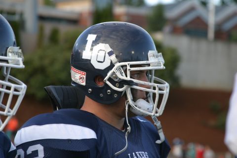 1993 Ford Bronco - A football player wearing a dark blue uniform and helmet with "LO" visible on the side.