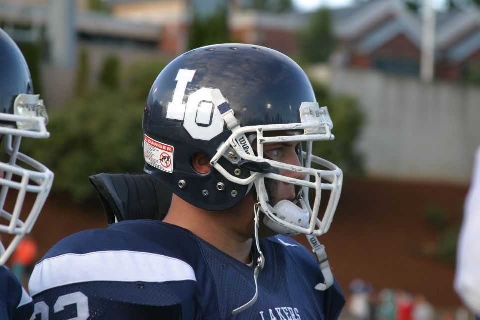 Football player in uniform with "LO" on helmet