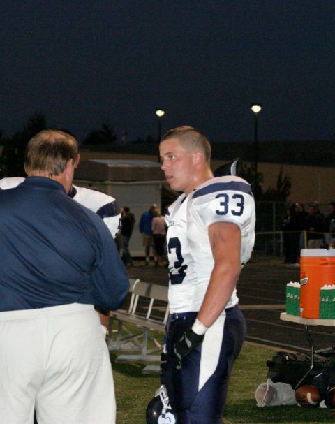 1993 Ford Bronco - Football player number 33 and coach on the sideline during a game.