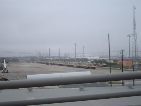 1989 Ford Bronco - Many military tanks are lined up in an outdoor lot under a hazy sky.