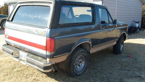 1995 Ford C-150 (Centurion Conversions) - Rear quarter view of a Ford Bronco, showing its two-tone paint scheme and removable hardtop.