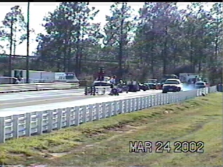 1997 Ford Taurus - Drag racing event captured on March 24, 2002, with multiple vehicles on the track.