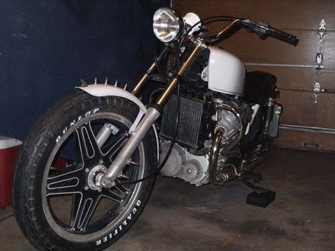 1978 Honda CB500T - A custom motorcycle is parked indoors, showing its front wheel and engine details.