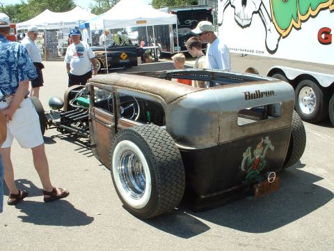1989 Ford Bronco - A custom rat rod with a unique paint job and exposed engine components is displayed outdoors.