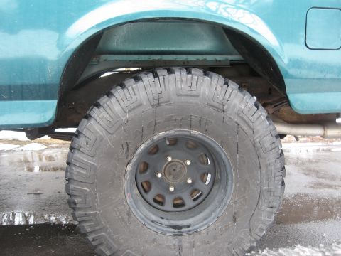 1996 Ford Bronco - Close-up of the rear wheel well and tire on a 1996 Ford Bronco.